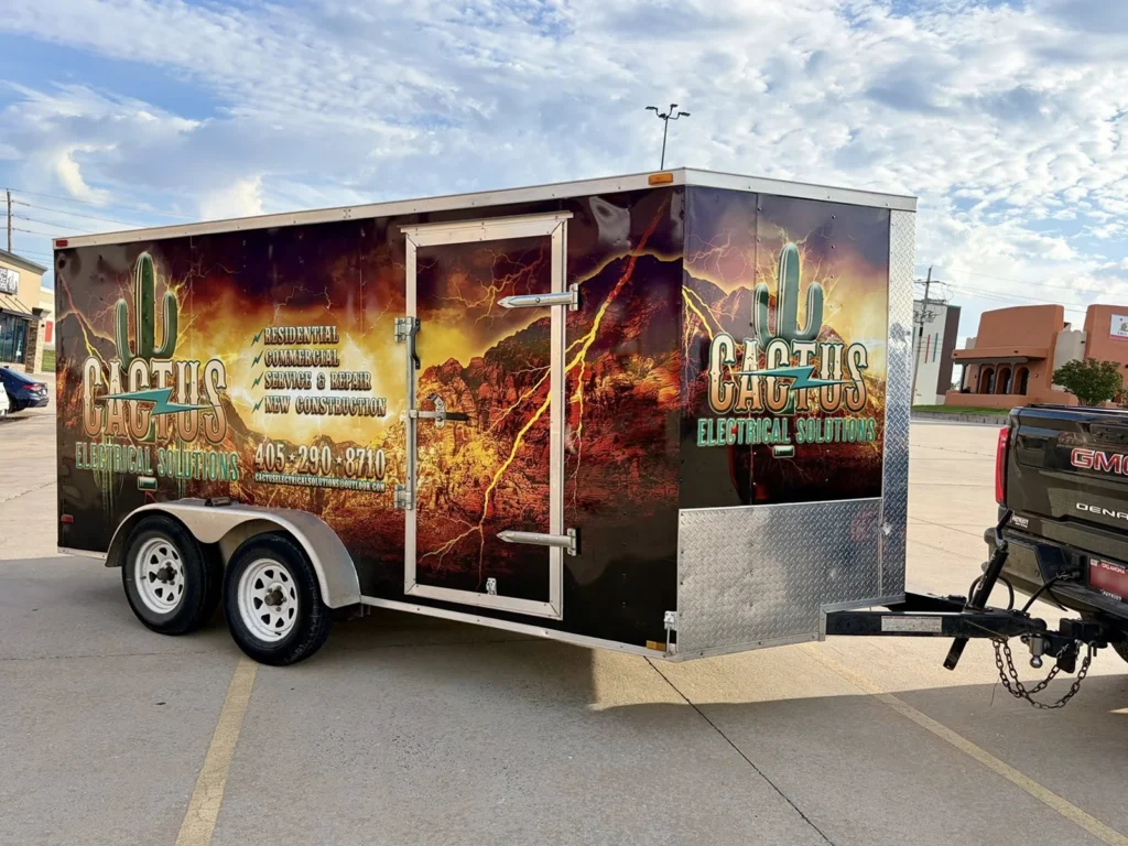 An electricians truck trailer with a vehicle wrap that is eye-catching.